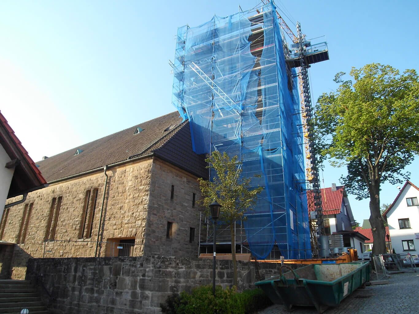 Blick auf eingehüllten Kirchturm während der Sanierungsphase durch BCH